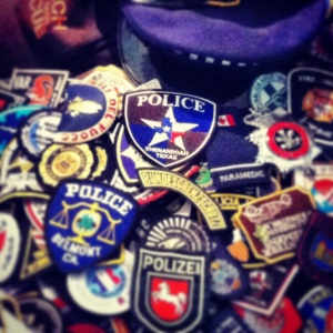 A Texas patch on the top of the pile of patches from the dispatchers that helped with 9/11.